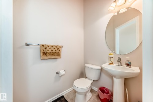 Bathroom featuring toilet and tile patterned flooring - 4619 151 Avenue Nw, Edmonton, AB - Indoor Photo Showing Bathroom