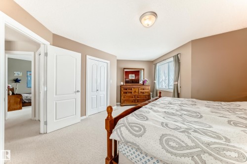 Bedroom featuring light colored carpet and a closet - 4619 151 Avenue Nw, Edmonton, AB - Indoor Photo Showing Bedroom