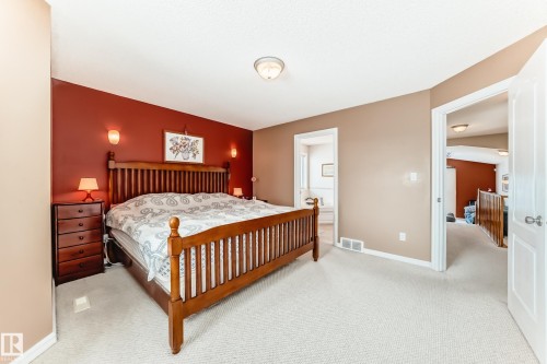 Bedroom with light carpet and ensuite bath - 4619 151 Avenue Nw, Edmonton, AB - Indoor Photo Showing Bedroom