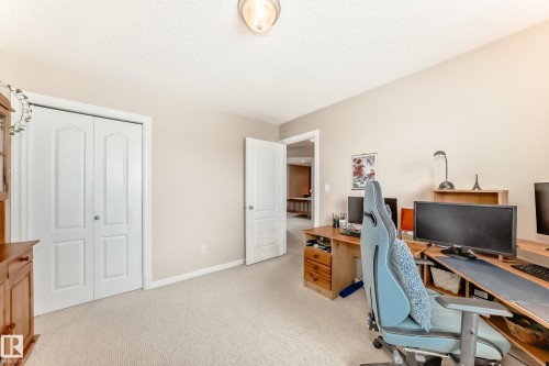 Home office with light carpet and a textured ceiling - 4619 151 Avenue Nw, Edmonton, AB - Indoor Photo Showing Office