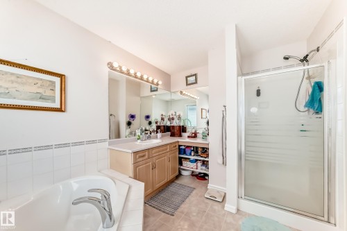 Full bath with vanity, a shower stall, a bath, and light tile patterned floors - 4619 151 Avenue Nw, Edmonton, AB - Indoor Photo Showing Bathroom