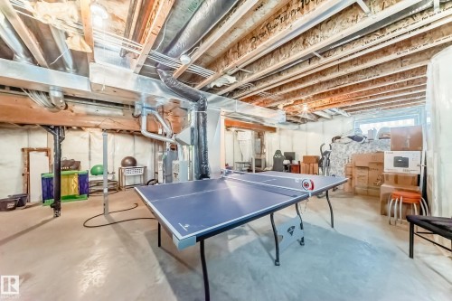 Playroom with concrete floors - 4619 151 Avenue Nw, Edmonton, AB - Indoor Photo Showing Basement
