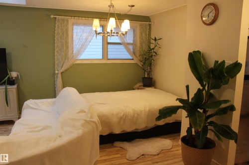 Bedroom with wood finished floors and suspended lighting - 12432 134 Street, Edmonton, AB - Indoor Photo Showing Bedroom
