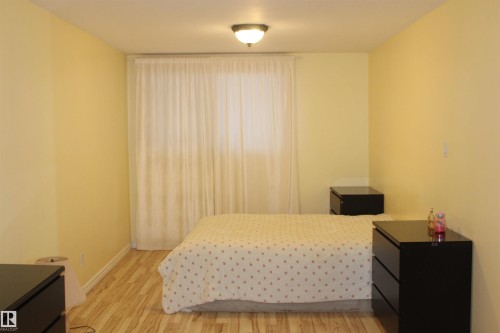 Bedroom featuring light wood-type flooring - 12432 134 Street, Edmonton, AB - Indoor Photo Showing Bedroom