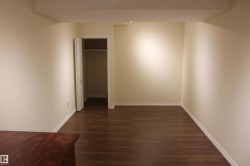 Unfurnished bedroom featuring dark wood finished floors and a closet - 