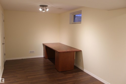 Unfurnished office with dark wood-type flooring and baseboards - 12432 134 Street, Edmonton, AB - Indoor Photo Showing Other Room