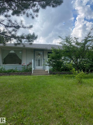 View of front of house featuring a front yard, a porch, and a shingled roof - 12432 134 Street, Edmonton, AB - Outdoor