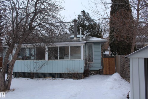 Snow covered property featuring a sunroom - 12432 134 Street, Edmonton, AB - Outdoor