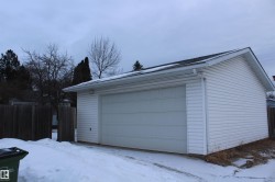 Snow covered garage featuring a detached garage - 