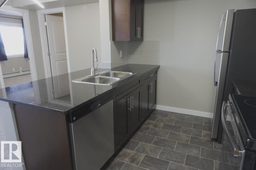 409 5810 Mullen Place, Edmonton, AB - Indoor Photo Showing Kitchen With Double Sink