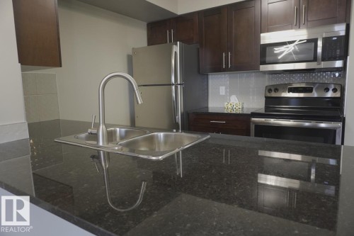 409 5810 Mullen Place, Edmonton, AB - Indoor Photo Showing Kitchen With Stainless Steel Kitchen With Double Sink With Upgraded Kitchen