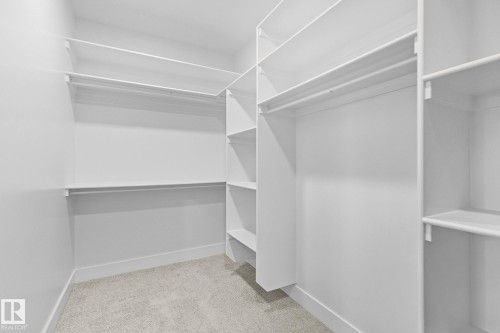 Walk in closet with light colored carpet - 523 Ashgrove Circle, Leduc, AB - Indoor With Storage
