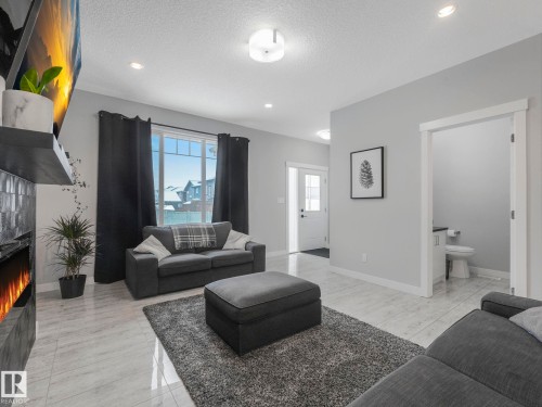 Living room featuring a fireplace, recessed lighting, and a textured ceiling - 3510 48 Avenue, Beaumont, AB - Indoor Photo Showing Living Room
