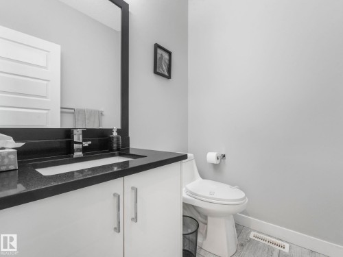 Half bathroom featuring vanity and baseboards - 3510 48 Avenue, Beaumont, AB - Indoor Photo Showing Bathroom