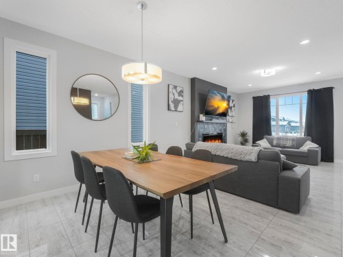 Dining room featuring a tiled fireplace and recessed lighting - 3510 48 Avenue, Beaumont, AB - Indoor Photo Showing Dining Room