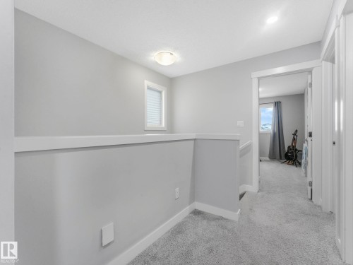 Hallway featuring light colored carpet and an upstairs landing - 3510 48 Avenue, Beaumont, AB - Indoor Photo Showing Other Room