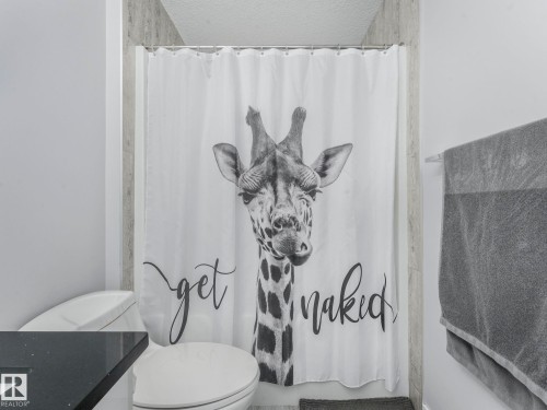 Full bathroom with vanity, shower / tub combo with curtain, and a textured ceiling - 3510 48 Avenue, Beaumont, AB - Indoor Photo Showing Bathroom