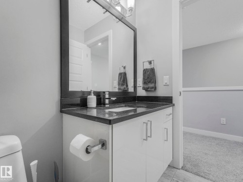 Bathroom featuring vanity, light colored carpet, and a textured ceiling - 3510 48 Avenue, Beaumont, AB - Indoor Photo Showing Bathroom