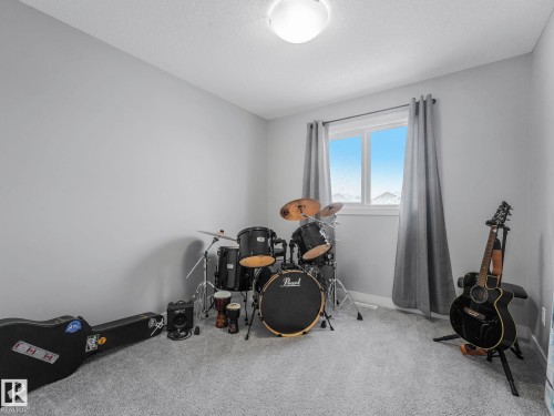 Playroom featuring light carpet and a textured ceiling - 3510 48 Avenue, Beaumont, AB - Indoor