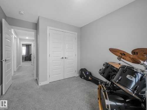 Misc room featuring light carpet and a textured ceiling - 3510 48 Avenue, Beaumont, AB - Indoor Photo Showing Other Room