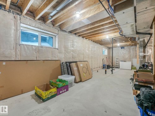 Basement with white fridge - 3510 48 Avenue, Beaumont, AB - Indoor Photo Showing Basement