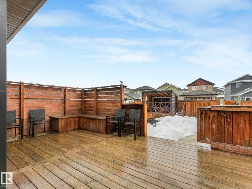 Wooden terrace with a residential view and a fenced backyard - 3510 48 Avenue, Beaumont, AB - Outdoor With Deck Patio Veranda With Exterior