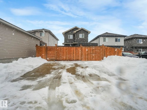 Yard layered in snow featuring a residential view - 3510 48 Avenue, Beaumont, AB - Outdoor