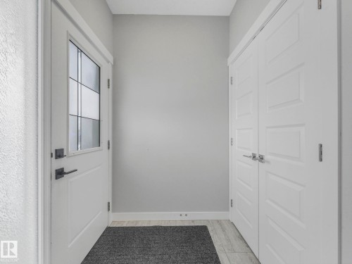 Doorway with wood finished floors and baseboards - 3510 48 Avenue, Beaumont, AB - Indoor Photo Showing Other Room