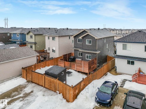 Back of house featuring a wooden deck, a residential view, and a fenced backyard - 3510 48 Avenue, Beaumont, AB - Outdoor With Deck Patio Veranda With Exterior