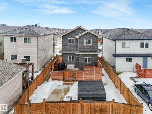 Snow covered rear of property with a residential view and a fenced backyard - 3510 48 Avenue, Beaumont, AB - Outdoor