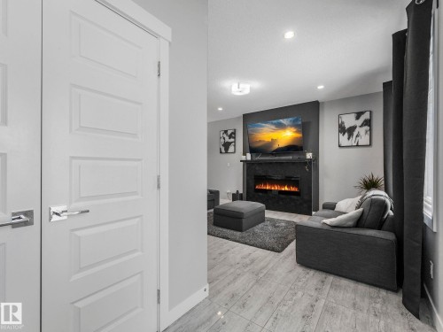 Living room featuring a tile fireplace and recessed lighting - 3510 48 Avenue, Beaumont, AB - Indoor Photo Showing Other Room