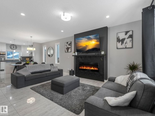 Living room featuring a glass covered fireplace and recessed lighting - 3510 48 Avenue, Beaumont, AB - Indoor Photo Showing Living Room With Fireplace