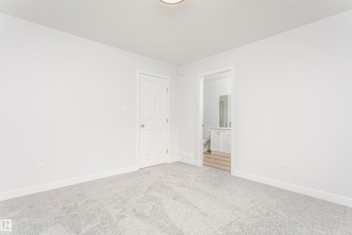 Unfurnished room featuring baseboards and carpet - 9564 Carson Bend, Edmonton, AB - Indoor Photo Showing Other Room