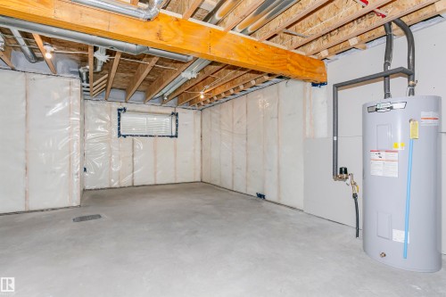 Unfinished basement featuring water heater - 9564 Carson Bend, Edmonton, AB - Indoor Photo Showing Basement