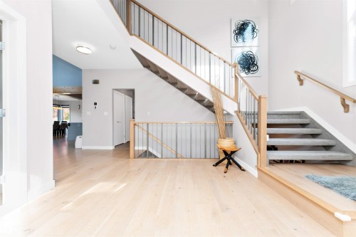 Stairway with wood finished floors and a high ceiling - 7404 May Common, Edmonton, AB - Indoor Photo Showing Other Room