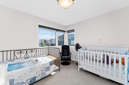 Bedroom with light colored carpet and baseboards - 7404 May Common, Edmonton, AB - Indoor Photo Showing Bedroom