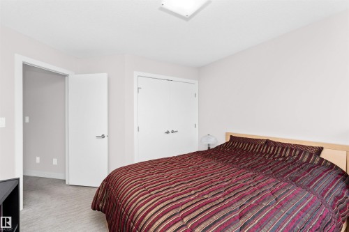 Bedroom with a closet and light carpet - 7404 May Common, Edmonton, AB - Indoor Photo Showing Bedroom