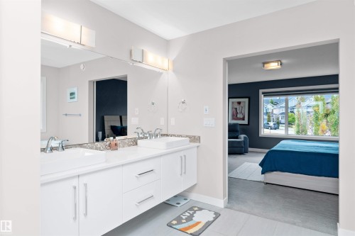 Ensuite bathroom with double vanity and light tile patterned floors - 7404 May Common, Edmonton, AB - Indoor Photo Showing Bathroom