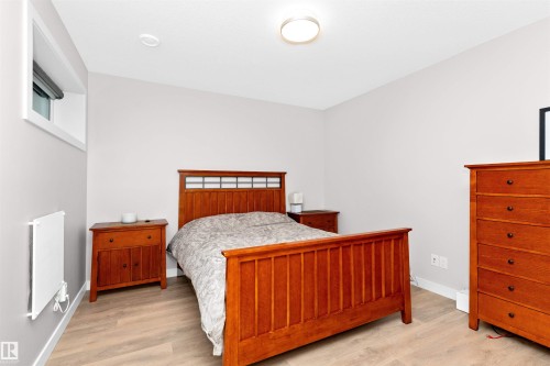 Bedroom with light wood-style floors and baseboards - 7404 May Common, Edmonton, AB - Indoor Photo Showing Bedroom