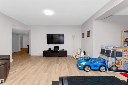 Living area featuring light wood finished floors and recessed lighting - 7404 May Common, Edmonton, AB - Indoor