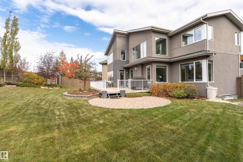 Back of house featuring a wooden deck, stucco siding, and a fenced backyard - 7404 May Common, Edmonton, AB - Outdoor With Deck Patio Veranda