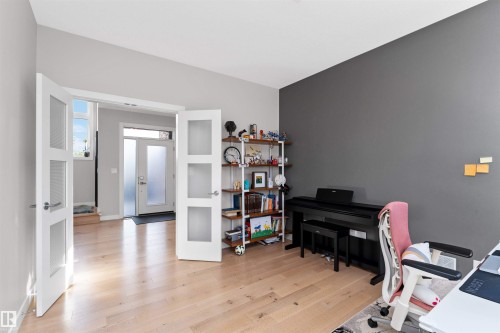 Home office featuring light wood-style flooring and french doors - 7404 May Common, Edmonton, AB - Indoor Photo Showing Office
