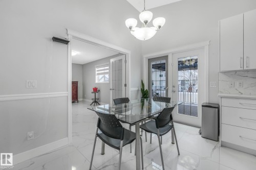 Dining area with french doors and a chandelier - 2919 151A Avenue, Edmonton, AB - Indoor