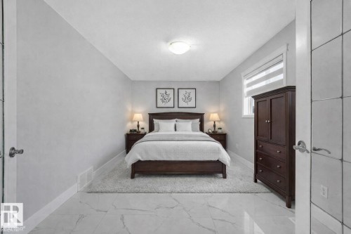 Bedroom with light marble finish flooring and baseboards - 2919 151A Avenue, Edmonton, AB - Indoor Photo Showing Bedroom