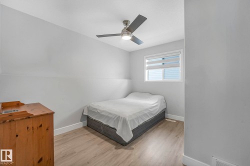 Bedroom with light wood-type flooring and a ceiling fan - 2919 151A Avenue, Edmonton, AB - Indoor Photo Showing Bedroom