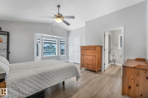 Bedroom with vaulted ceiling, light wood-type flooring, ceiling fan, a closet, and ensuite bathroom - 2919 151A Avenue, Edmonton, AB - Indoor Photo Showing Bedroom