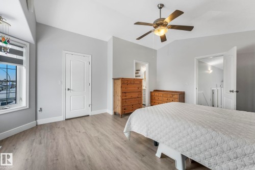 Bedroom featuring light wood finished floors, a ceiling fan, and lofted ceiling - 2919 151A Avenue, Edmonton, AB - Indoor Photo Showing Bedroom