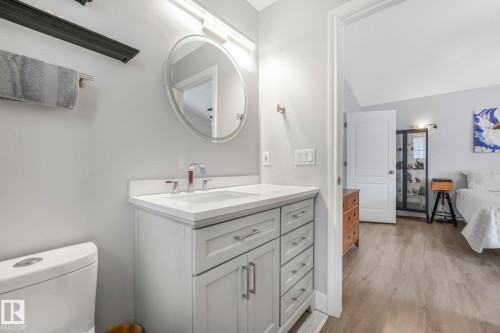 Bathroom with vanity, light wood finished floors, and lofted ceiling - 2919 151A Avenue, Edmonton, AB - Indoor Photo Showing Bathroom