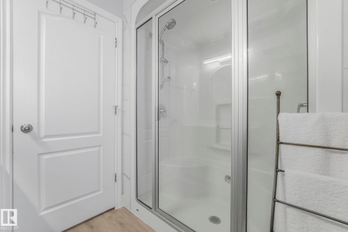 Full bathroom featuring a stall shower and light wood-type flooring - 2919 151A Avenue, Edmonton, AB - Indoor Photo Showing Bathroom