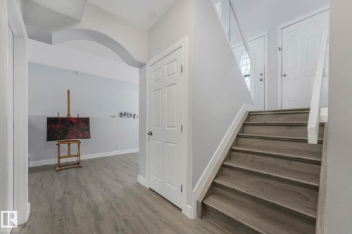 Stairway with baseboards and wood finished floors - 2919 151A Avenue, Edmonton, AB - Indoor Photo Showing Other Room